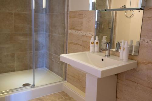 a bathroom with a sink and a shower at Oak Cottage, Castle Carrock, Nr Carlisle in Castle Carrock
