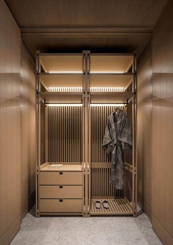 a walk in closet with a wooden gate and a dresser at Nobu Hotel Toronto in Toronto