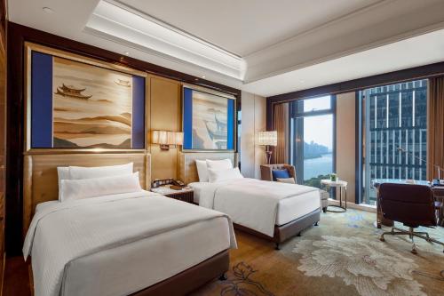 Ένα ή περισσότερα κρεβάτια σε δωμάτιο στο Wanda Vista Changsha