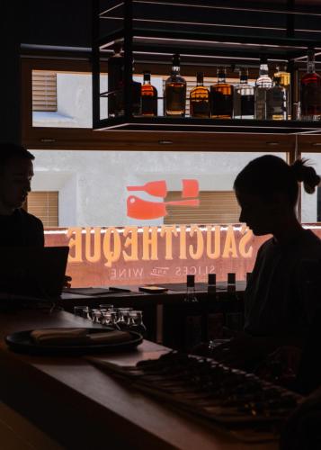 a couple of people sitting at a bar with a keyboard at Hôtel Borsari, A Member of Design Hotels in Martigny-Ville