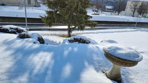 a snow covered yard with a fire hydrant covered in snow at Luxuriöse Villa Romantica in Gampel