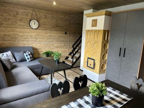 a living room with a couch and a table at Chata Bosorečka in Smižany