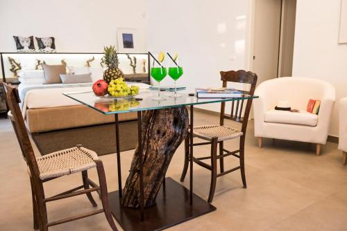 a living room with a glass table and chairs at Riofavara Winery in Val di Noto in Ispica