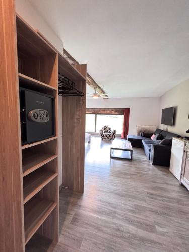 a living room with a couch and a television in a room at domaine du vernay in Mazille