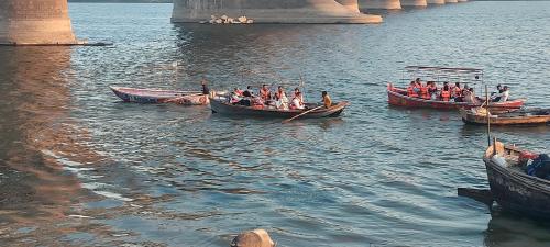 a group of people in boats on the water at Cozy haven stays in Prayagraj
