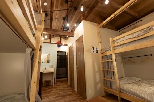 Postel nebo postele na pokoji v ubytování 千寿宿 玄