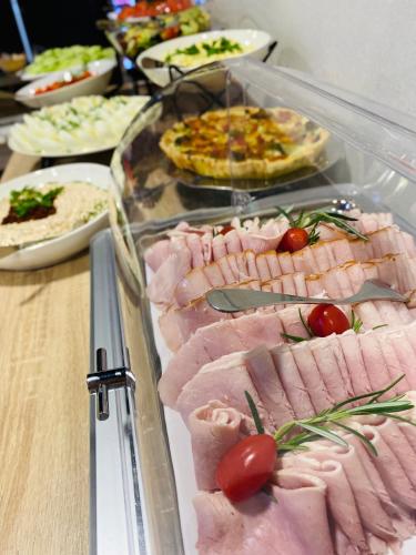 a buffet with many different types of meats and pizzas at Hotel Basztowy in Sandomierz