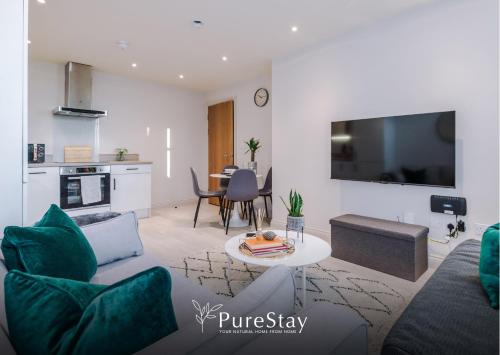 a living room with a couch and a table and a tv at Leeds Business Stays 1-Bedroom Flat with 2 Beds & Sofa Bed - 7 nights min! in Leeds
