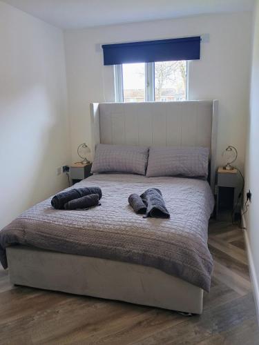 a bedroom with a bed with two pillows on it at Mulberry Holiday Home in Great Yarmouth