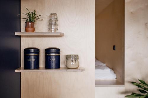 a shelf in a room with jars on it at Zwier, de Vrijhaven in Vinkeveen