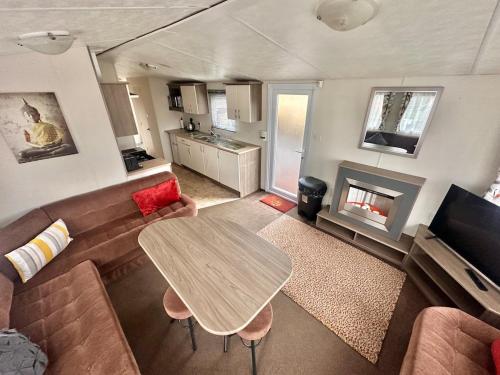 a living room with a couch and a table at Delta, Bromley 4-Bedroom Located in Uddingston, Glasgow at Maryville Caravan Site in Uddingston