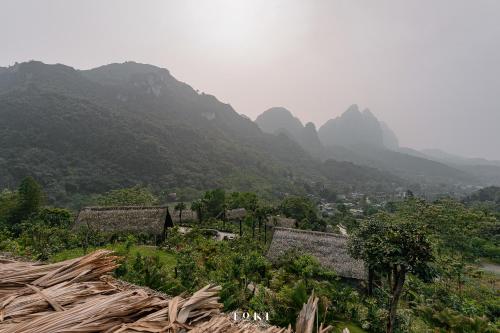 a view of a village with mountains in the background at TOKI Ecolodge Cao Răm in Hòa Bình