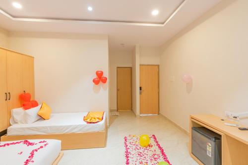 a small room with a bed and a tv at Serene Resort Hyderabad in Shamshabad