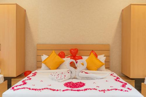 a bed with colorful pillows and decorations on it at Serene Resort Hyderabad in Shamshabad
