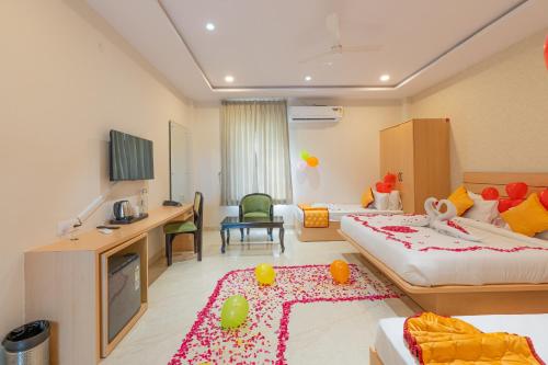 a hotel room with two beds and a living room at Serene Resort Hyderabad in Shamshabad