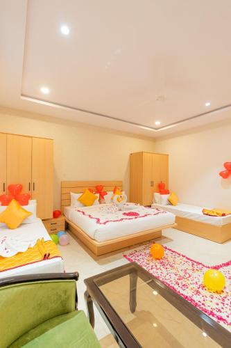 a room with two beds and a glass table at Serene Resort Hyderabad in Shamshabad