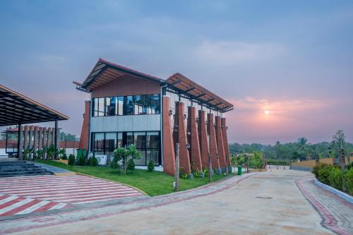 a university building with a sunset in the background at Serene Resort Hyderabad in Shamshabad