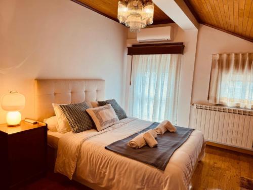 a bedroom with a bed with two towels on it at A casa do Boubelo in Vimioso