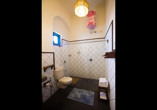 a bathroom with a toilet and a sink at Rokeby Manor in Mussoorie