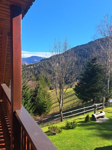 a porch of a house with a view of a mountain at Na Rebri in Luče