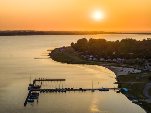 an aerial view of a dock on a lake at sunset at RCN Vakantiepark de Schotsman in Kamperland
