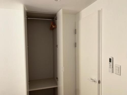 a walk in closet with a glass door at Mangwon Hangang Park House 3 rooms or one room in Seoul