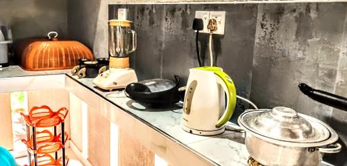 a kitchen counter with various appliances on it at Bee Line Cinnamon Estate Villa in Dickwella
