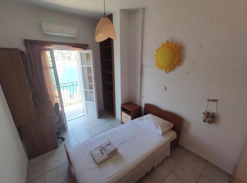 a bedroom with a bed and a mirror on the wall at Sunflower House in Vathi, Ithaka