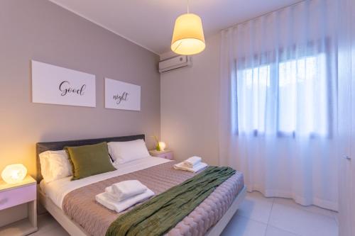 a bedroom with a bed with towels on it at Isola di Albarella in Isola Albarella