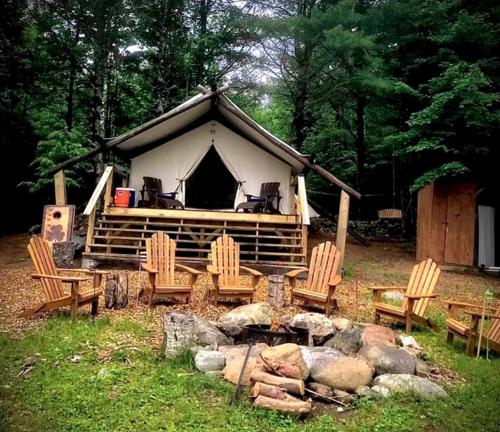 a group of chairs sitting in front of a tent at Gorgeous Safari Tent Rental Ideal for Glamping in Upstate New York in Wevertown