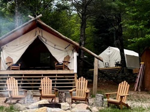 a group of chairs sitting in front of a tent at Gorgeous Safari Tent Rental Ideal for Glamping in Upstate New York in Wevertown