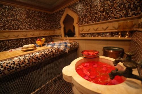 a bathroom with a bath tub filled with red liquid at Glavatarski Han in Glavatartsi