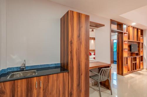 a kitchen with a sink and a desk at Daan Residency Near Karukapilly Kaloor Palarivattom in Ernakulam