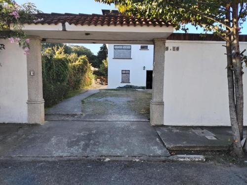 an entrance to a white building with a garage at L´Aurora Inn hostal in Guatemala