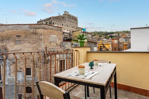 a table on a balcony with a view of a building at Casa Annunziata - Bronte in Bronte