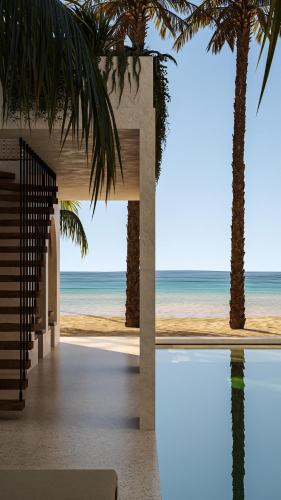 a view of the beach from a house with palm trees at Neem - Raw Luxury Boutique Hotel Madiha - adults only in Kamburugamuwa