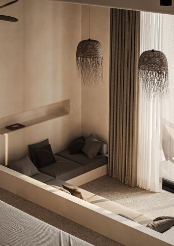 a living room with a couch and two chandeliers at Neem - Raw Luxury Boutique Hotel Madiha - adults only in Kamburugamuwa