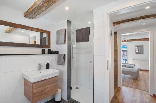 a white bathroom with a sink and a shower at Erlebnis-Bauernhof Scheunenglück in Oberkirch