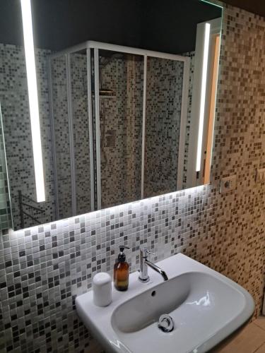 a bathroom with a sink and a mirror at La dimora dalle Mura in Savona