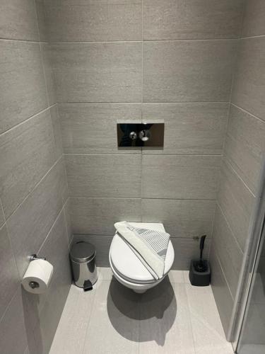 a small bathroom with a toilet and a trash can at OSIRIS HOTEL APARTMENTS and STUDIOS in Ialyssos