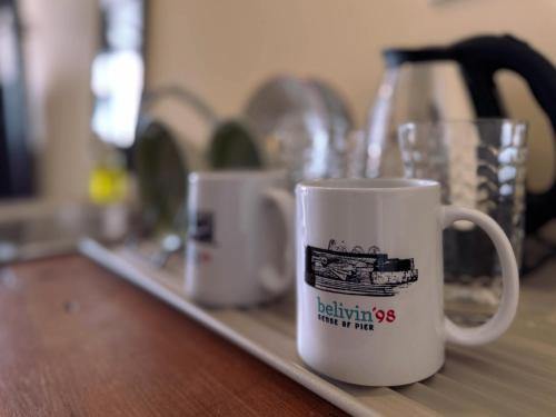 a coffee mug is sitting on a counter at Belivin'98 Sense of Pier Sathorn Residence in Bangkok