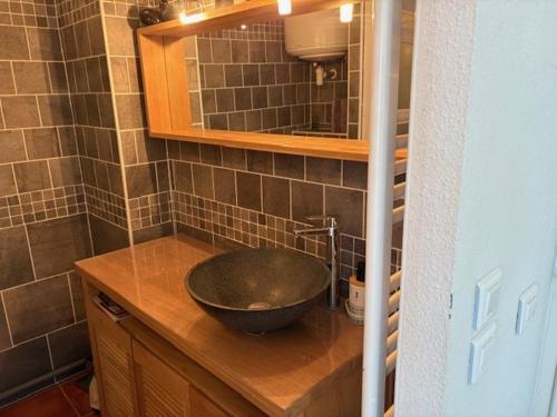 a bathroom with a bowl sink on a counter at NATURA LOFT in Cap d'Agde
