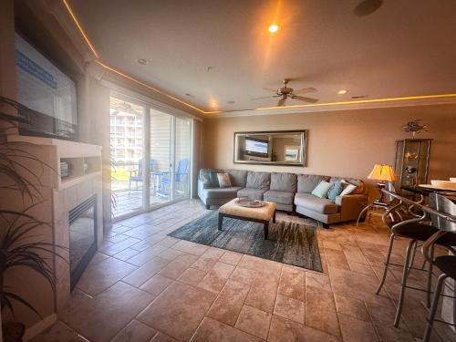 a living room with a couch and a table at Lakefront Lands End Luxury 3bed2bathpools in Osage Beach