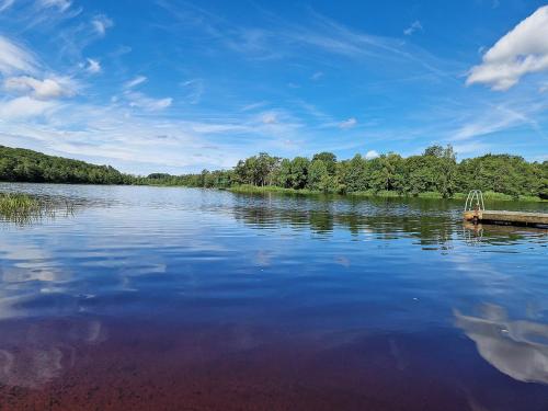 a large lake with a dock in the middle of it at EFS-gården Åsljunga in Åsljunga