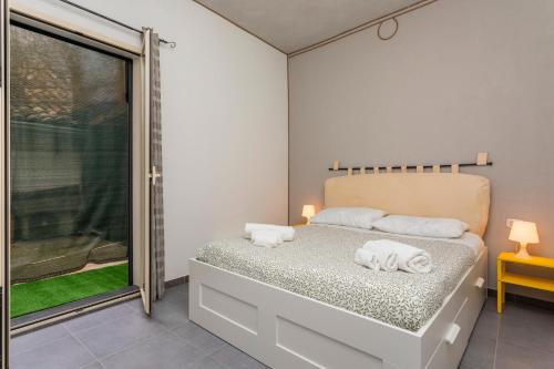 a bedroom with a bed with towels on it at Casa Annunziata - Bronte in Bronte