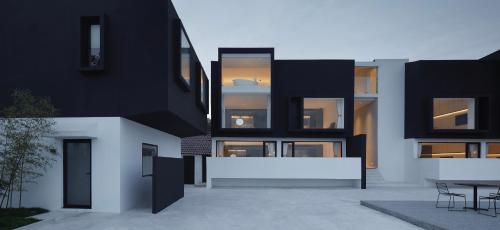 a black and white building with a table in a courtyard at the house of mo in Shanghai