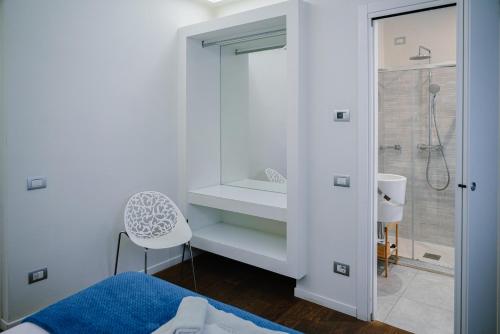 a bathroom with a shower and a bed and a sink at La Corte sul Naviglio in Boffalora sopra Ticino