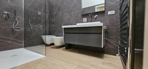 a bathroom with a sink and a shower and a toilet at Luxury way Gocce di Lusso in Molfetta