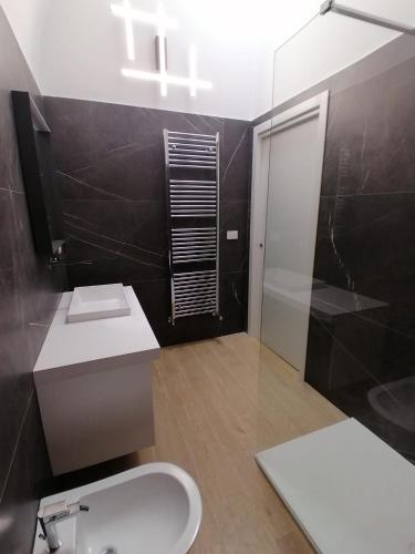 a bathroom with a toilet and a sink and a shower at Luxury way Gocce di Lusso in Molfetta