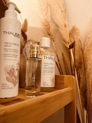 three bottles of hair products sitting on a shelf at SPONGIA HOTEL SUITES & Spa in Myrties
